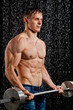 Wet muscle sexy young man with weight under the rain in studio