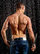 Wet muscle sexy young man back under the rain in studio