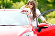 © Sergey - Young pretty woman in the red car