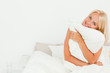 © WavebreakmediaMicro - Cute woman holding a pillow