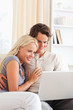© WavebreakmediaMicro - Portrait of a lovely young couple using a laptop