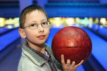 Portrait Of Boy In Glasses, Which Hold Ball For Bowling