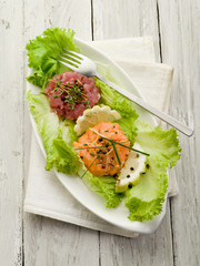 Canvas Print - salmon and tuna tartare with green salad