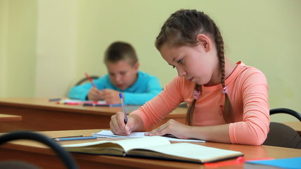 Poster - Little girl fulfilling written tasks in school