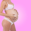 © Adam Radosavljevic - Pregnant woman holding tummy