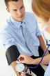 © Monkey Business - Young man having blood pressure taken