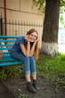 © Nikita Vishneveckiy - smiling girl sitting on a park bench