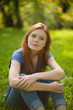 © Nikita Vishneveckiy - beautiful red-haired girl sitting on grass