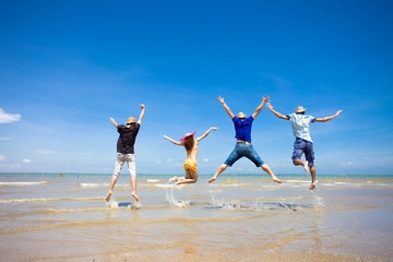 people jumping at the beach