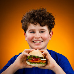 Wall Mural - Boy eating big hamburger