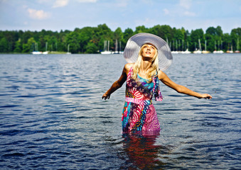 Beautiful blond model standing on water.