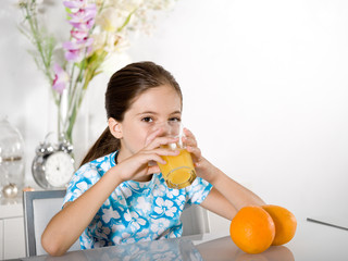 little girl drinking orange juice