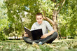 © luckybusiness - student reading book in park