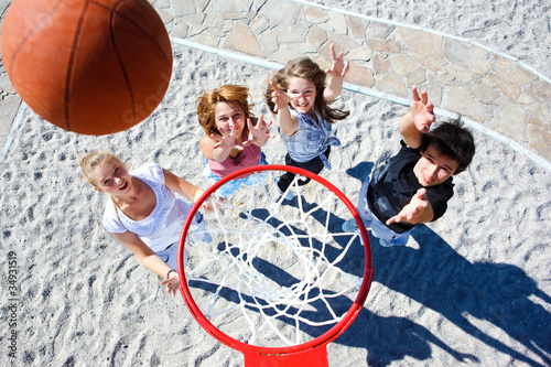 Fototapeta na wymiar Teenagers playing basketball