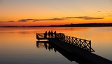 Fototapeta Fototapety pomosty - People on the pier at sunset