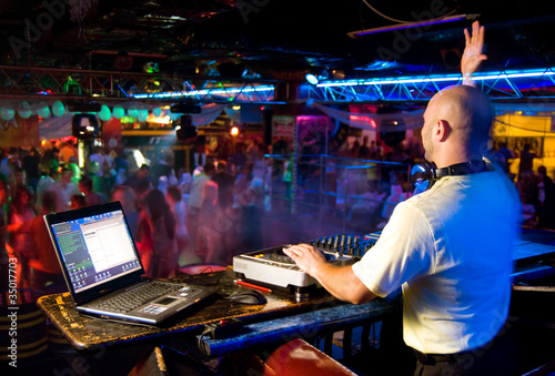 Fotografie, Obraz Dj mixes the track in the nightclub at a party