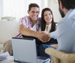 © JGI/Jamie Grill/Blend Images - Couple greeting finance advisor