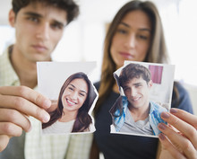 Couple Holding Torn Photograph