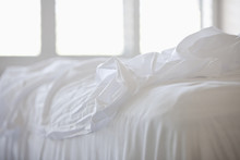 Close Up Of White Sheets On Bed