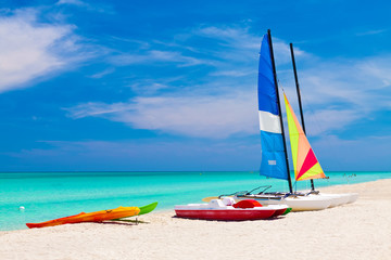 Wall Mural - Sailing boats and water bikes in the cuban beach of Varadero