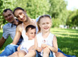 © Sergey Nivens - Family with two children in the summer park