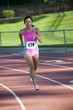 © Pete Saloutos/Blend Images - Japanese relay runner running with baton