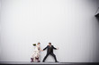 © Kyle Monk/Blend Images - Playful bride and groom standing near wall