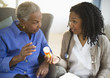 © JGI/Tom Grill/Blend Images - Nurse explaining medication to woman