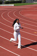 © jeffwqc - Young black woman running on track sweat suit