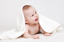 Cute Baby Smiling Under White Blanket