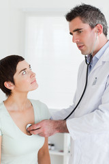 Doctor examining a charming woman