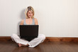 © Darrin Henry - Happy young girl on floor surfing internet at home
