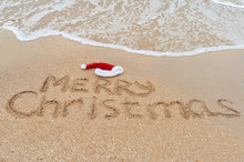 Merry Christmas Written On Tropical Beach Sand