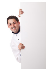 Male chef holding blank board