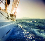 Yacht Sailing against sunset.Sailboat.Sepia toned