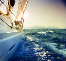 Yacht Sailing Against Sunset.Sailboat.Sepia Toned