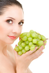 Wall Mural - Pretty woman with grape on the white background