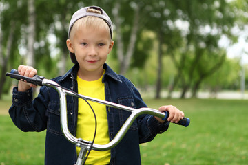 Boy on a bicycle in the green park