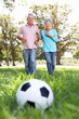 © Monkey Business - Senior couple playing football