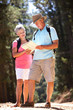 © Monkey Business - Senior couple reading map on country walk