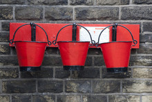 Three Old Red Fire Buckets At A Railway Station