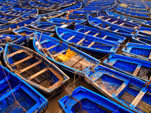 Blue Fishing Boats Tied Together In Harbor