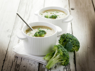 Wall Mural - broccoli soup on bowl over wood background