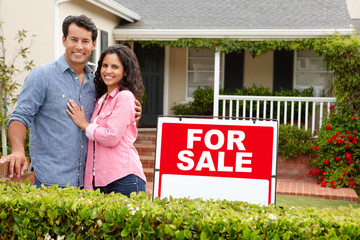 Wall Mural - Hispanic couple outside home with for sale sign