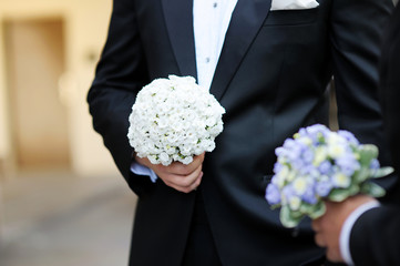 Poster - Groom and a bestman holding flowers during the wedding ceremony