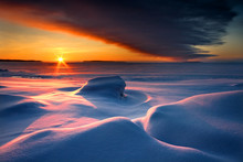 Snowy Seascape With Dark Cloud And Rising Sun
