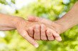 © mitarart - Closeup of old people hands holding together outdoor