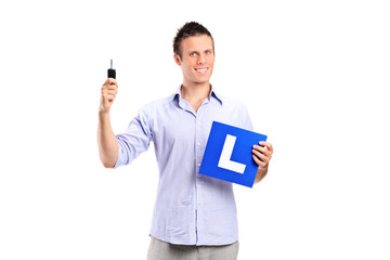 Happy man holding a car key and L plate