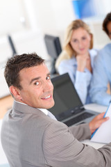 Couple with real-estate agent in office