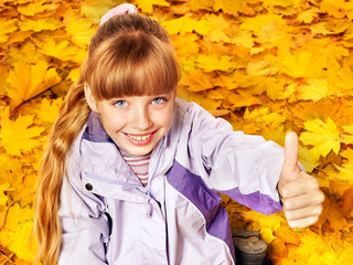 Wall Mural - kid in autumn orange leaves.